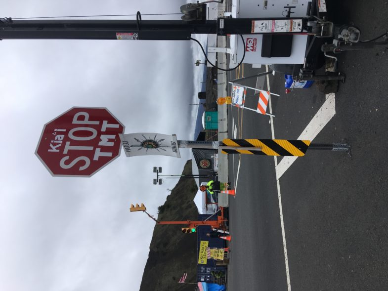 A stop sign at the Puʻuhonua reads “Kia‘i stop TMT.” Photo by Matt Ito. 