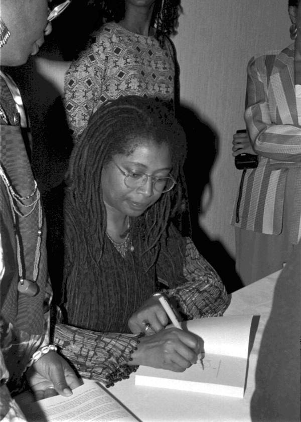 Alice Walker signing autographs at the Zora Neale Hurston Festival of the Arts and Humanities - Eatonville, Florida (1990) via Florida Memory: State Library and Archives of Florida, Folk Life Collection